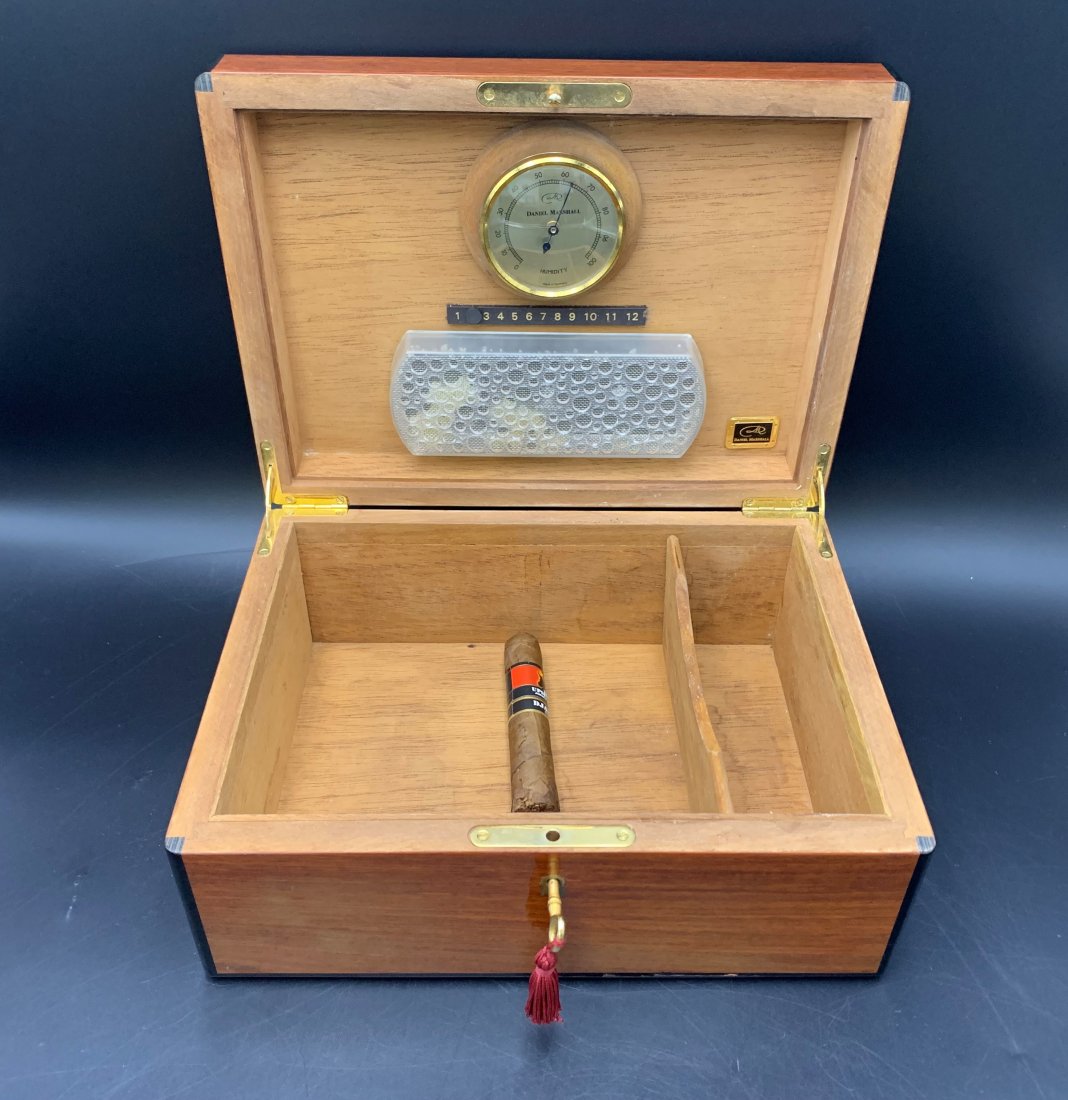 Daniel Marshall Hand Made Humidor: Daniel Marshall Hand Made Humidor. Humidor box comes with key. Humidor measures 5" height x 9" width x 12" length. In good condition.
