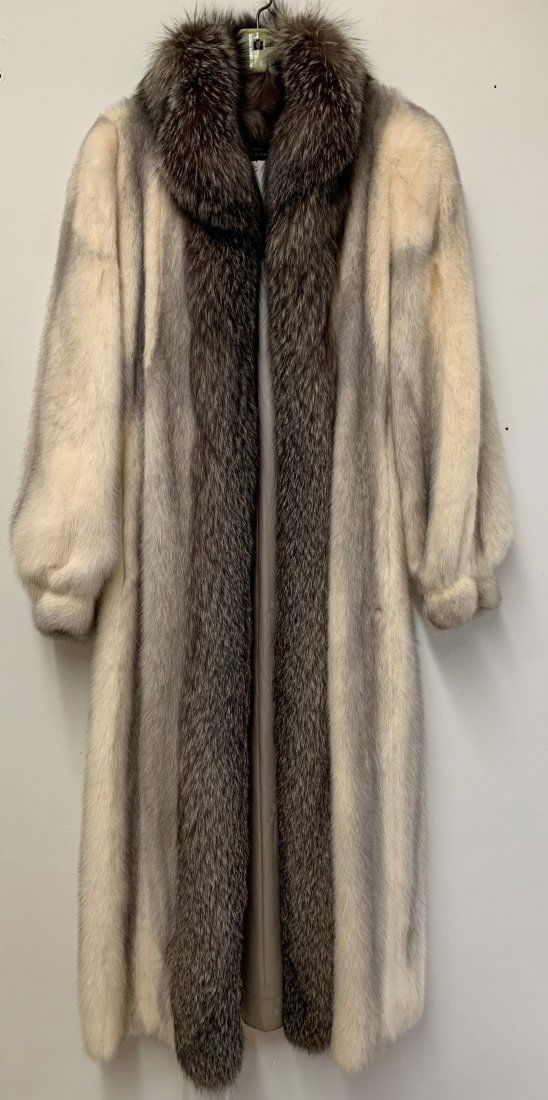 Ladies Silver Cross Mink Coat with Fox Trim: Ladies Silver Cross Mink Coat with Fox Trim. Mink coat measures 51 1/2" long x 18" shoulder to shoulder x 22" shoulder to cuff. Fox trims collar measures 4" wide. Coat has two pockets and silk lining