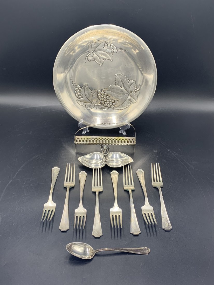 Estate Lot of Sterling Silver / Tiffany 30.1 troy oz: Estate Lot of Sterling Silver / Tiffany 30.1 troy ounces. (1) Large plate measures 10 1/2", (1) Tiffany angel ring holder, (8) forks, (1) spoon & (1) small sugar cube basket. In good condition.
