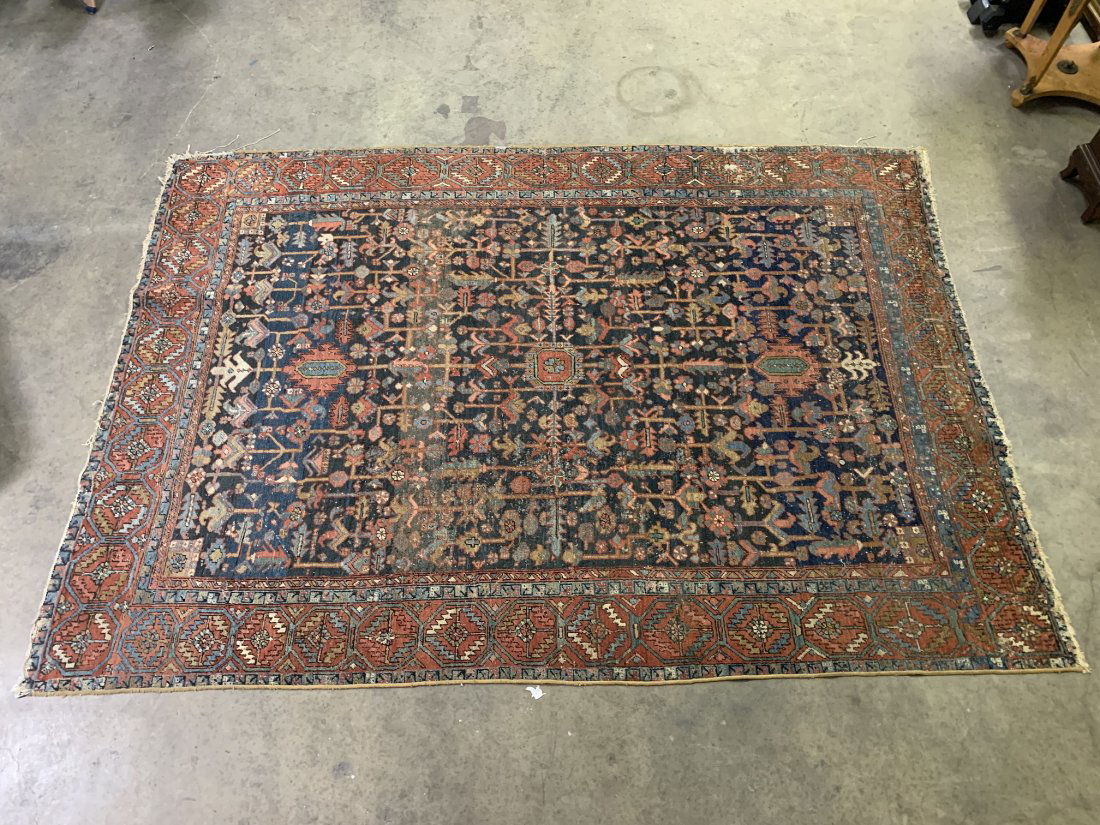 Antique Hand Knotted Persian Heriz Wool Rug 96" x 135": Antique Hand Knotted Persian Heriz Wool Rug. Persian rug measures 96" wide x 135" long. The rug has some wear & sings of moth damage. Please refer to pictures. Overall in fair condition.
