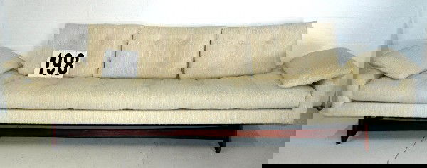 ADRIAN PEARSALL SOFA: LONG & SLEEK ADRIAN PEARSALL FOR CRAFT ASSOCIATES WHITE BENCH SEAT SOFA WITH SOLID WALNUT TRIM ORIGINAL TUFTED FABRIC UPHOLSTERY, 104L. MATCHES LOT 197.