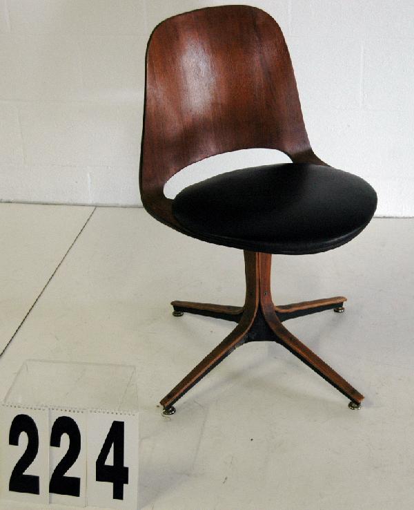 PLYCRAFT SWIVEL CHAIR: SIGNED AND DATED JAN 1965 PLYCRAFT WOODEN SWIVEL SHELL CHAIR WITH BLACK LEATHER CUSHION, PAPER LABEL.