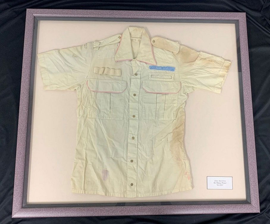 Crew Member Shirt from The Motion Picture "Alien": Crew Member Shirt from The Motion Picture "Alien". Initialed J.H. inside of collar. Attributed to John Hurt. The frame measures 34 1/2" tall x 38 1/2" wide. In good condition.