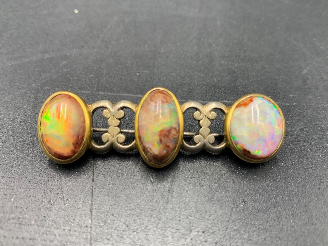 Vintage Brooch with Australian Jelly Opal Stones: Vintage Brooch with Opal Stones set in Sterling Silver. Marked Tiffany & Co. The brooch measures 2". The opal stone measures 15.8mm to 13.1mm & weights: 15g. In good condition.
