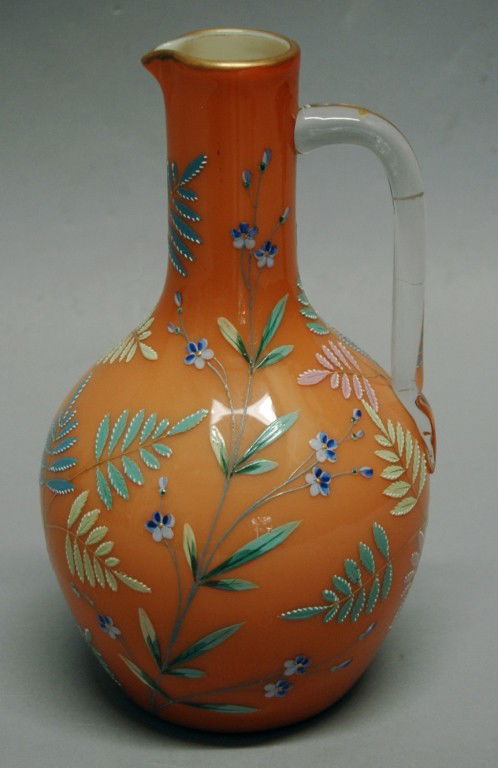 Thomas Webb Enameled Ewer: Thomas Webb all-over enameled ewer, multi-colored ferns and flowers on orange background, 10" h.