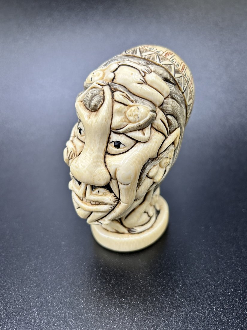 Japanese Carved Erotic Okimono Skull: Japanese Carved Erotic Okimono Skull. Early 20th Century carved figurine skull representing a man's head formed by female bodies. Markings on bottom of piece. Figure measures 3.25" tall and weighs 6 O