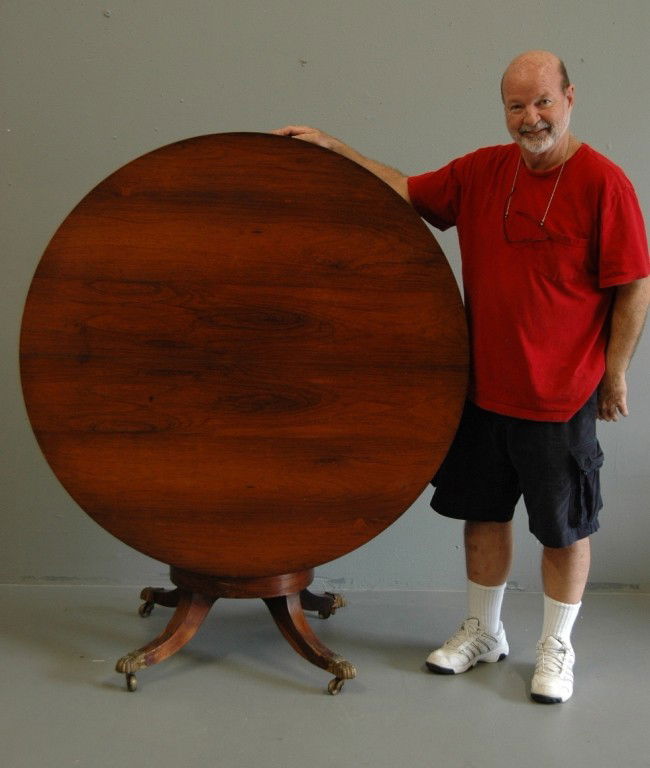 Regency Period Breakfast Table: Regency period tilt-top breakfast table in rosewood veneers, single urn pedestal base with 4 brass cap legs, 48dia, 29h, c 1840s.