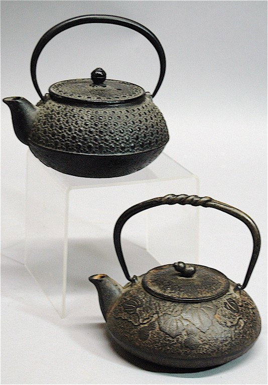 2 Cast Iron Japanese Tea Pots: 2 cast iron Japanese tetsuban tea pots, both with raised cipher signatures, largest 6 x 6.