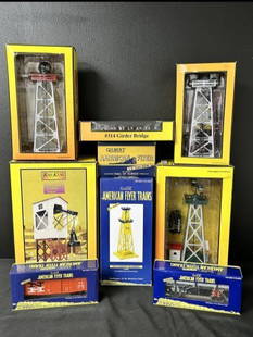 Lot of 9 Rail King & American Flyer Trains in Original Box: Lot of 9 Rail King & American Flyer Trains in Original Box. (1) New Haven gondola with pipes No.48879. (1) Waffle sided boxcar No.15120. (1) Whistling Billboard No.568. (1) Sunoco oil derrick