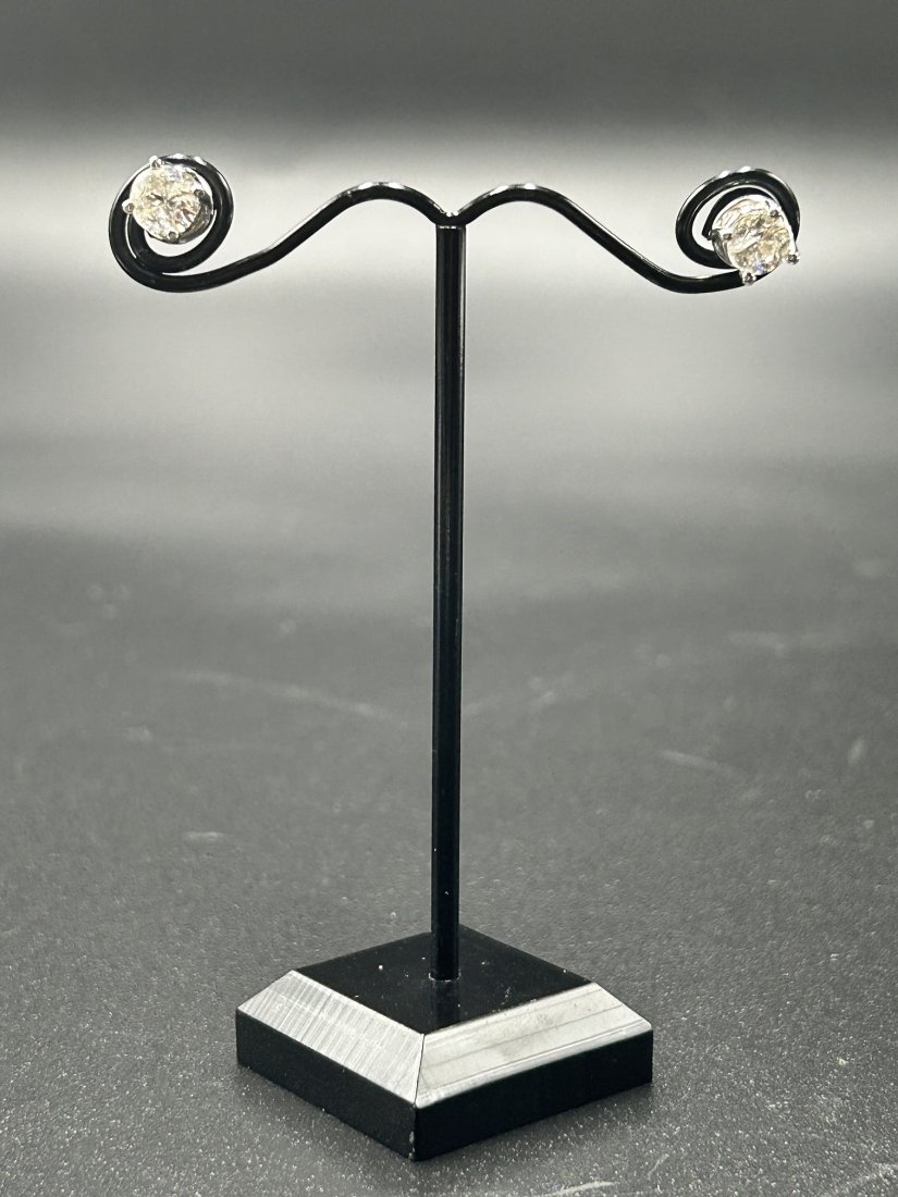1.5 Center Diamond TDW & 14K White Gold Earrings: 1.5 TDW Center Diamond & 14K White Gold Earrings. 18 diamond total. Two 3/4 kt. each center diamonds & 8 small diamonds on the base of each earrings. Measurements: 5.3 mm. Total approximately diamond 