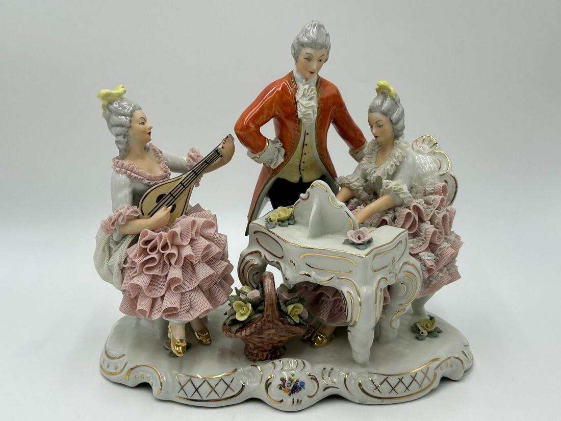 Dresden Sandizell Lace Porcelain Musical Concert Figures: Dresden Sandizell Lace Porcelain Musical Concert Figures. Piece features a stage, with 2 young ladies and a gentleman, possilby a music instructor overseeing the ladies playing the mandolin and piano.