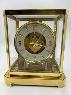 Atmos by Jaeger LeCoultre Mantel Clock: Atmos by Jaeger LeCoultre Mantel Clock. 15 Jewel, gold plated clock. Swiss made with serial number 199161. Side pins pull out to remove glass case of clock. We believe the clock is in working conditio