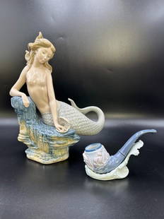 Estate Lot of Retired Lladro Mermaid "Sirena De La Pearla and Sealore Pipe & Holder: Estate Lot of Retired Lladro Mermaid "Sirena De La Pearla and Sealore Pipe & Holder. The Lladro mermaid is sitting on a rock form with her hand in a clam shell holding a pearl. Bottom has Lladro logo