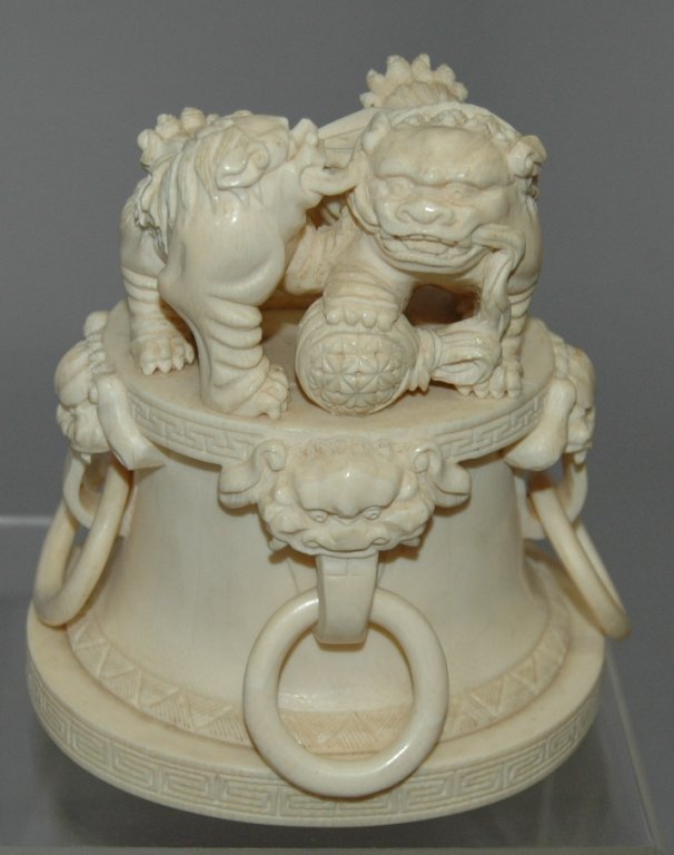 Carved Chinese Ivory Foo Dogs: Carved Chinese ivory Foo dogs atop plinth with 4 rings, one solid piece of ivory, has split on one area, 5.5 x 5.5, excellent condition. Possible lid for larger piece?