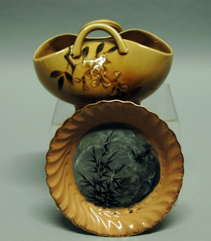 2 Pieces of Rookwood Pottery: 2 very early examples of Rookwood Art Pottery by Anna Marie Bookprinter, fold-over footed vase with two handles and floral decoration 4.5 x 7.5, dated 1886. Oriental influenced plate, 6.5dia, with bam