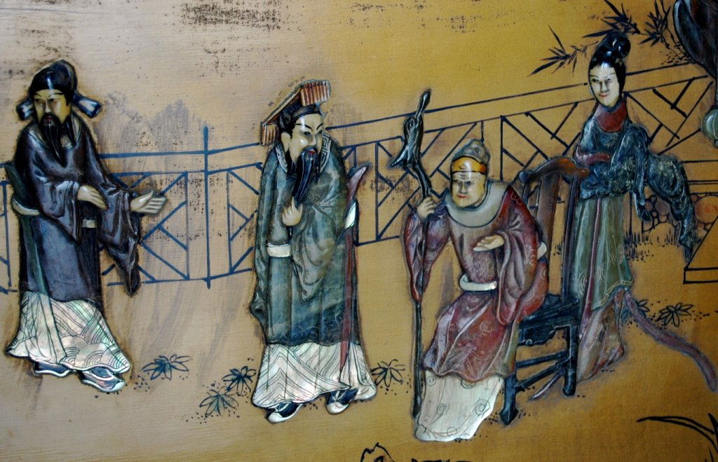 Chinese Panel with Applied Figures: Chinese panel with applied figures, 6 people on gold lacquered and layered panel. Figures are carved soapstone, abalone, and ivory faces. Background has evidence of alligatoring on finish in upper lef