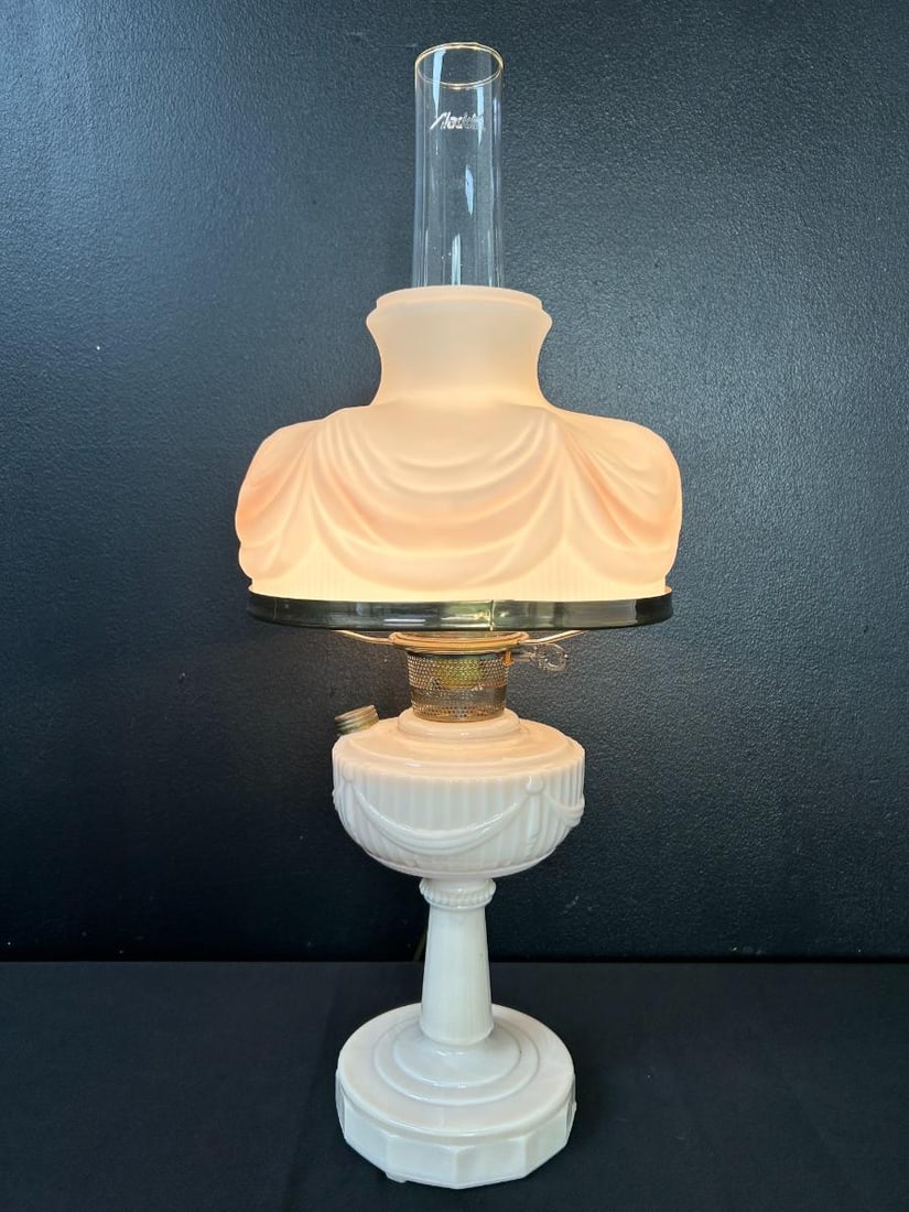 Vintage Lincoln Drape Pink Alacite Aladdin Electric Oil Lamp: Vintage Lincoln Drape Pink Alacite Aladdin Electric Oil Lamp. Pale pink in color, Alacite described as "an ivory opal glass" with original Aladdin chimney (some of the lettering is rubbed). No chips o