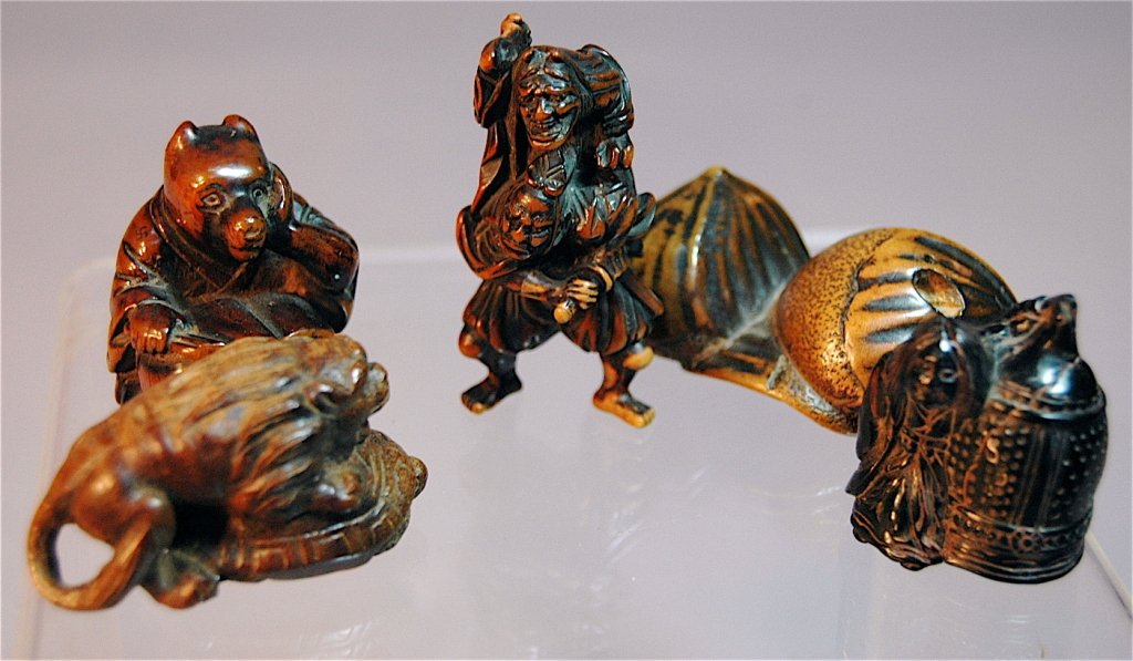 Group of 5 Wood Carved Netsukes: Group of 5 carved wood netsukes: chestnut wood "chestnuts", lion on turtle's back, witch with a barrel, Oni-watanabe tsuma Gyokusen man carrying demon on his back, bear reading a book by Tanuki, all g