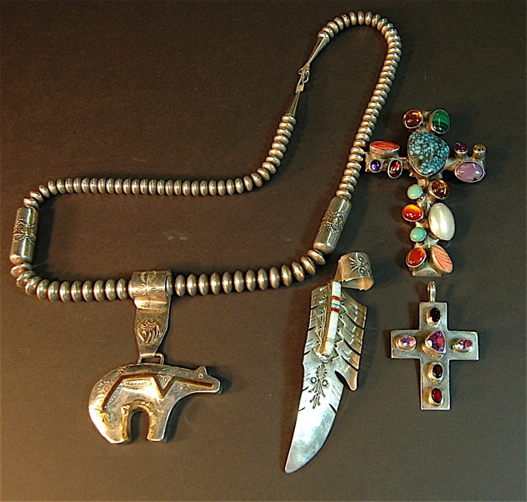 Southwest Native American Jewelry Group: Southwest Native American sterling jewelry group: sterling silver necklace with sterling bear pendant, "feather" by DD, large crucifix inset with 16 stones, and smaller crucifix set with 6 cut amethys