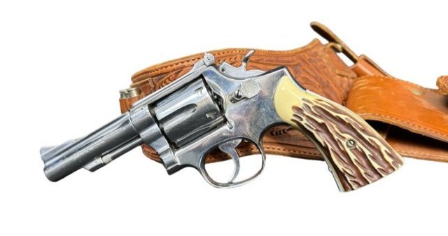 Smith & Wesson 38 Special Nickel Plated Double Action Revolver with Leather Holster: Smith & Wesson 38 Special Nickel Plated Double Action Revolver with Leather Holster. The Serial Number K 321982 is on the bottom of the grip frame. The right side of the barrel a symbol is rubbed , ab