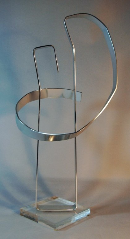 Dan Murphy Aluminum Sculpture: Dan Murphy signed aluminum sculpture on square plexi-glass stand. 25.5h, 13w, dated 1976.