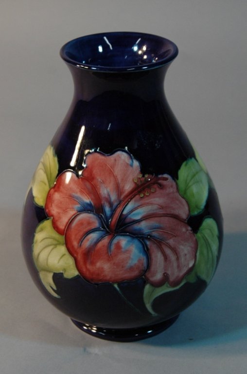 Moorcroft Cobalt Hibiscus Vase 8.5": Moorcroft cobalt background hibiscus vase, large example 8.5" tall, mint condition. Early impressed mark Moorcroft Made in England. Also painted script monogram of William J. Moorcroft.
