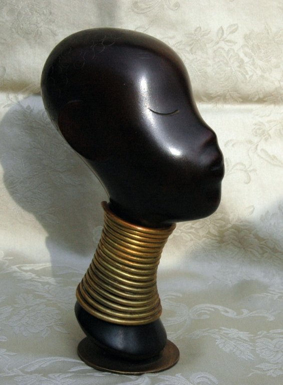 Franz Hagenauer Wood and Brass Sculpture: Franze Hagenauer wood and metal sculpture, carved bust of young African man with stylized features, elongated neck with brass rings around neck, 6.5". Excellent patina, marked on brass base with impre