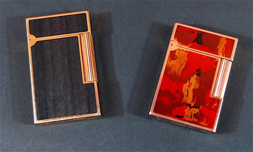 2 Dupont Cigarette Lighters: 2 Dupont cigarette lighters: Ebony and gold trim and multi-colored brush stroke enamel and gold. Both in fine working condition.