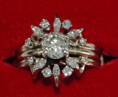 14K White Gold Wedding Set: 14K white gold wedding set. Approx. .5 carat solitaire engagement ring with double guard having 12 small surrounding diamonds. Not graded, straight from estate.