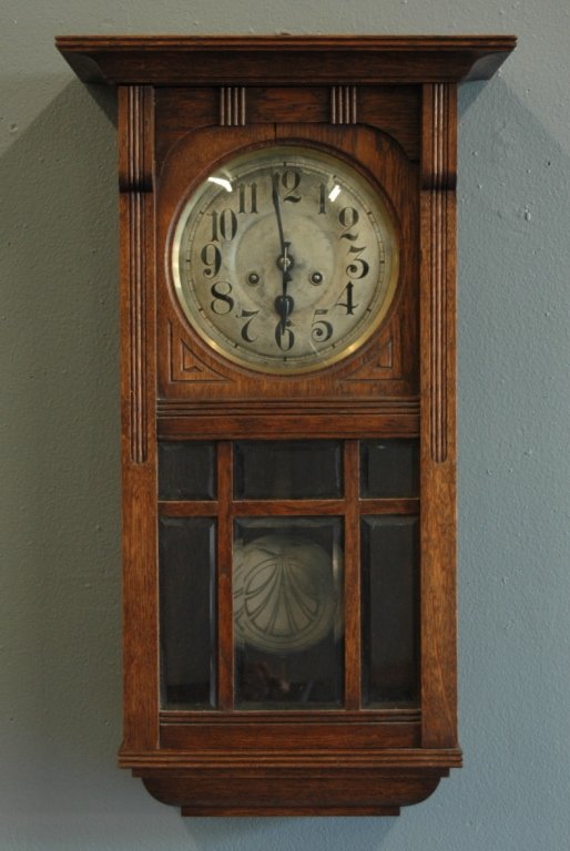 Arts & Crafts Wall Regulator Clock: Arts & Crafts wall regulator clock, Silesia, German, mullioned beveled glass door, stylized pendulum, 28h, 17w, good running condition.