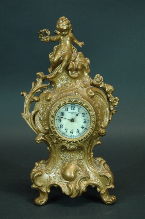 New Haven Art Nouveau Mantle Clock: New Haven Art Nouveau mantle clock in ornate metal case with cupid finial. 10.5h, clock is working, good condition