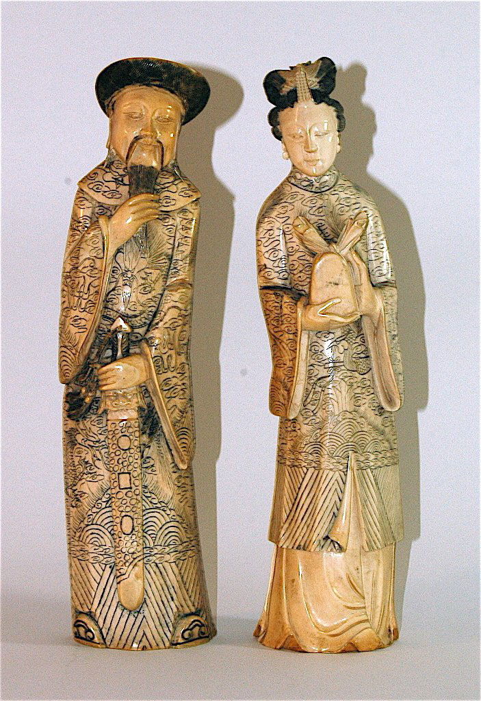 Pair Chinese Carved Ivory Male & Female: Pair Chinese carved ivory male and female figures. 10.25" tall, c 1900, all over scrimshaw etching, man holding sword, woman holding wrapped article, each signed, good condition.