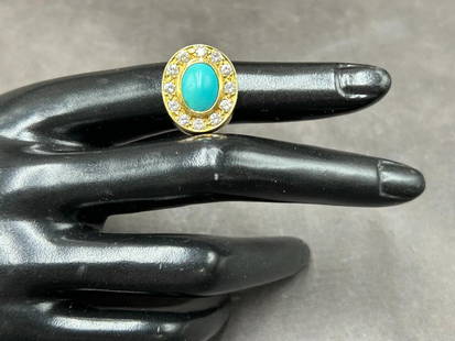 18K Gold Turquoise and Diamond Ring 10.73 grams: 18K Gold Turquoise and Diamond Ring 10.73 grams. Ring is set with (1) Oval Cabochon cut Turquoise and (12) diamond surrounding bezel. Polish finish, turqu"Persian" quality measuring 10.00 x 8.00 x 4.6