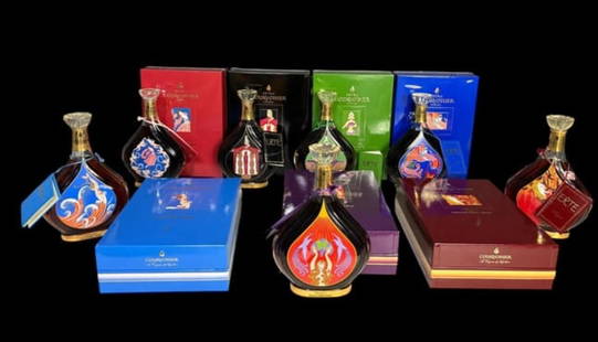 Estate Lot - 7 Sealed Decorative Collection Erte' Cognac Bottles in Collector Boxes: Estate Lot of 7 Sealed Decorative Collection Erte' Cognac Bottles in Collector Boxes. Each box and Courvoisier bottle depicts a different female scene in the classic Erte Art Deco style with both