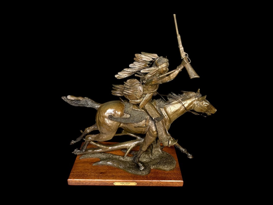 Bronze Sculpture by Jack Riley "Kiowa Raider" Ltd. Edition - 21" Tall: Bronze Sculpture by Jack Riley "Kiowa Raider" Ltd. Edition. This is a wonderful Western themed bronze by Jack Riley signed and numbered #9/15. It features a Indian in full attire with rifle raised in 