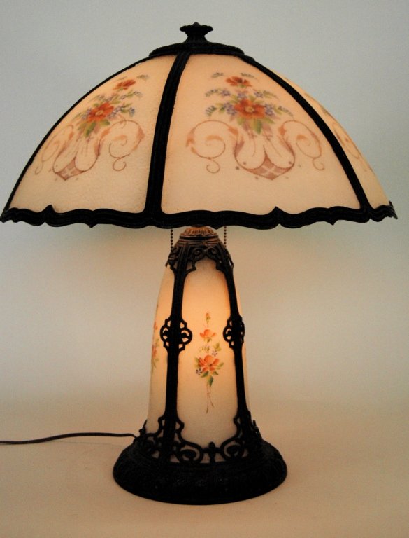 Pittsburgh Panel Lamp: Pittsburgh panel lamp, textured opaque panels with reverse painted floral and scrolls on each. Shade is 19" dia., overall 22.5" H. Base has 4 complimenting panels and interior light on separate switch