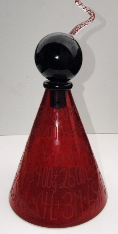 Duncan McClellan Blown Glass Sculpture: Duncan McClellan blown glass sculpture, 27" tall, 2 pieces comprising a pyramidal triangular red glass base with all over etched letters and numbers of a formula for making glass, black glass ball sto