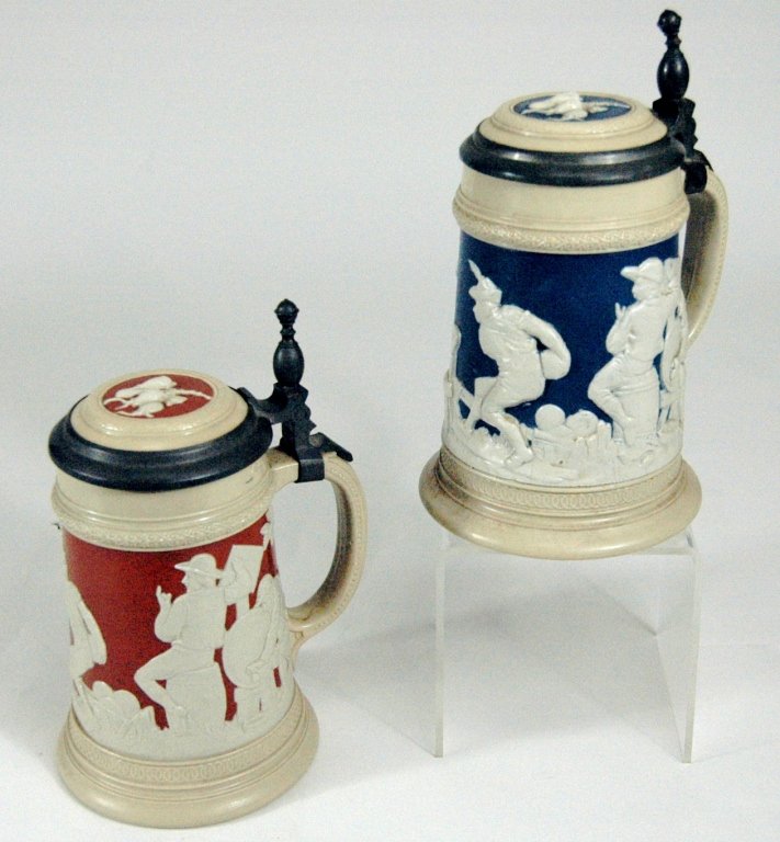 Villeroy and Boch Mettlach Steins (2): Villeroy and Boch Mettlach steins (2) #2182, cameo relief decorated, one reddish brown background, one blue, .5 liter, good condition.