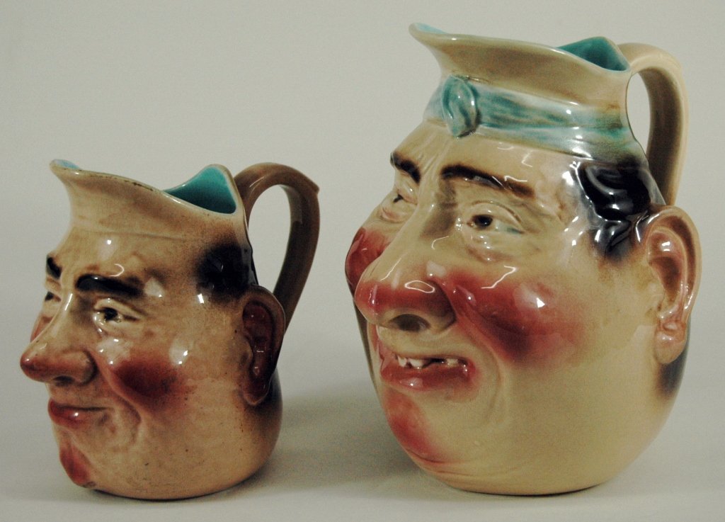 Sarreguemines Majolica Character Jugs (2): 2 Sarreguemines Majolica character jugs. Tallest 8.5", ink stamp manufacturers mark "Made in Germany" on both. Both impressed #3181, and Sarreguemines. Good condition, whimsical and colorful.