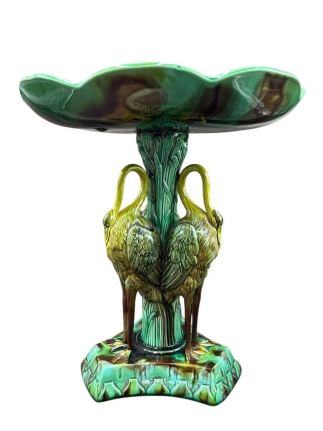 Antique Majolica Crane & Lily Pond Pedestal Centerpiece: Antique Majolica Crane & Lily Pond Pedestal Centerpiece. The ceramic pedestal shows three cranes leaning against branches holding up the pond of lily leaves with a center flower. (The stand is attribu