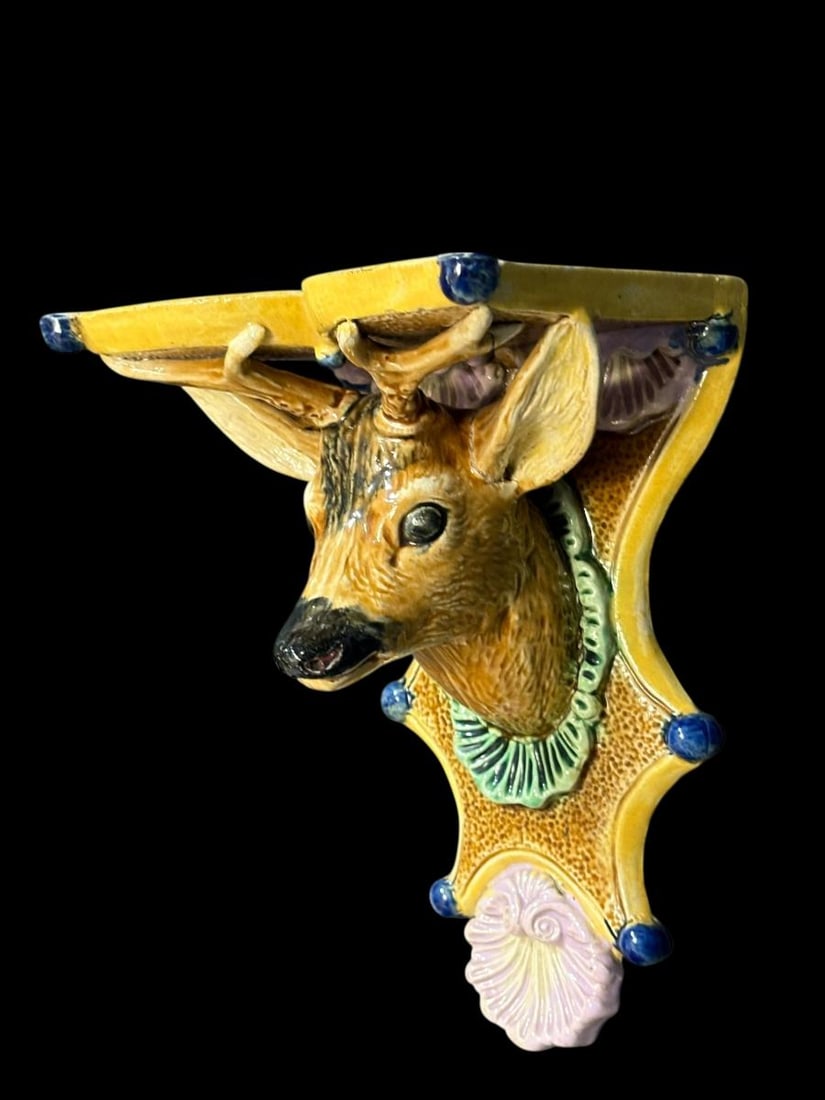 Majolica Pottery Stag Deer Wall Shelf: Majolica Pottery Stag Deer Wall Shelf . This is colorful piece showing a stags head with antlers holding up a small wall shelf. The colors and glaze are in good condition. Maybe signs of a repair