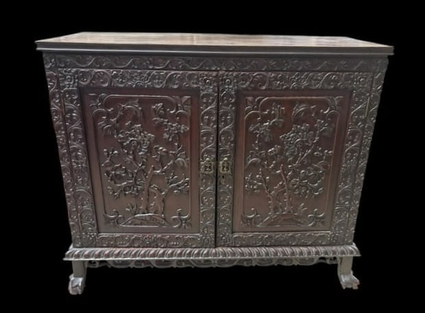 Late 19th Century Chinese Carved Rosewood Side Cabinet: Late 19th Century Chinese Carved Rosewood Side Cabinet. This is a ornate foliate relief carved front cabinet with 2 cupboard doors that open up to reveal a shelf and bottom for shelf for storage. 