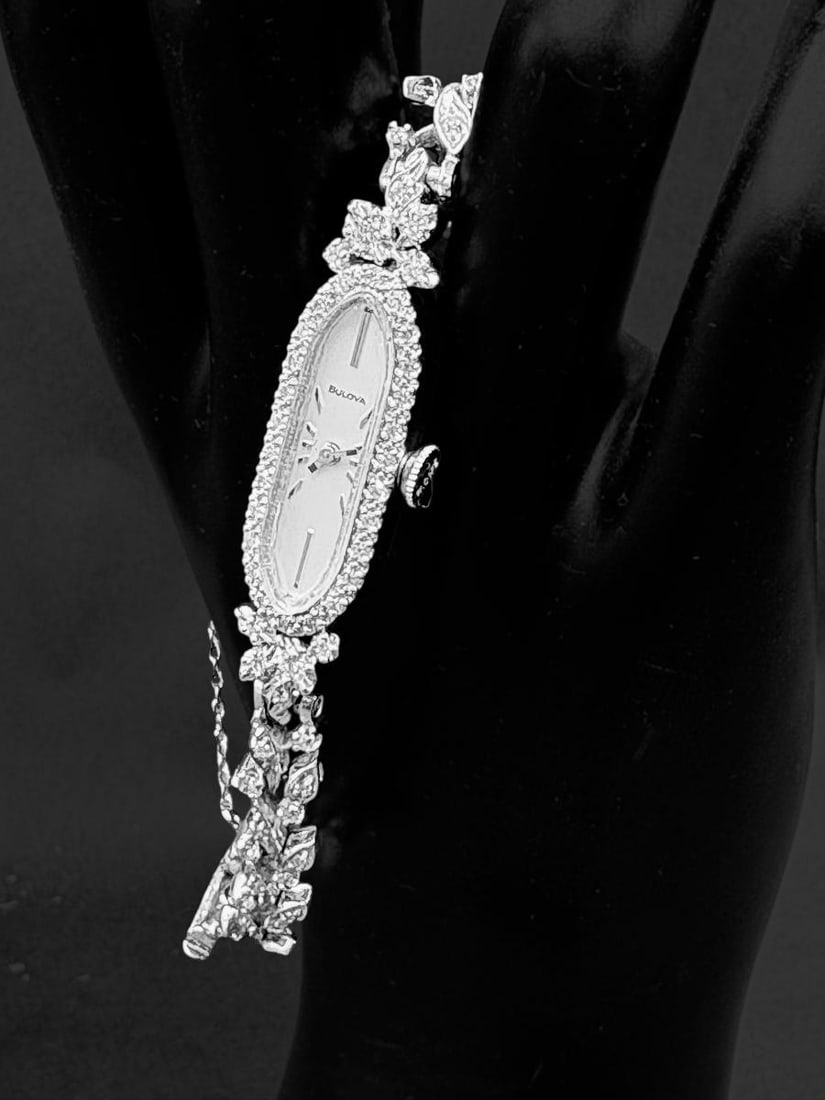 14k White Gold and Diamond Vintage Bulova Ladies Wristwatch 18 grams with Box: 14k White Gold and Diamond Vintage Bulova Ladies Wristwatch 18 grams with Box. This is a stunning vintage watch of 14k white gold with 1.25" long oval face marked Bulova surrounded by diamonds. The wr