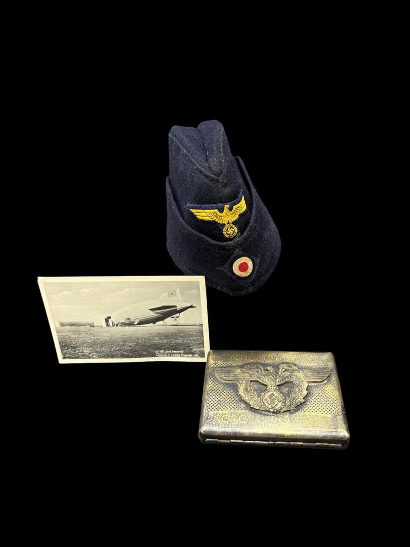 German WWII Military Items, Cap, Postcard & Cigarette Case: German WWII Military Items, Cap, Postcard & Cigarette Case. This lot contains a WWII Military Wool Cap (Paris 57), a black & white postcard LZ 130 Graf Zeppelin and metal cigarette case. All are in fa
