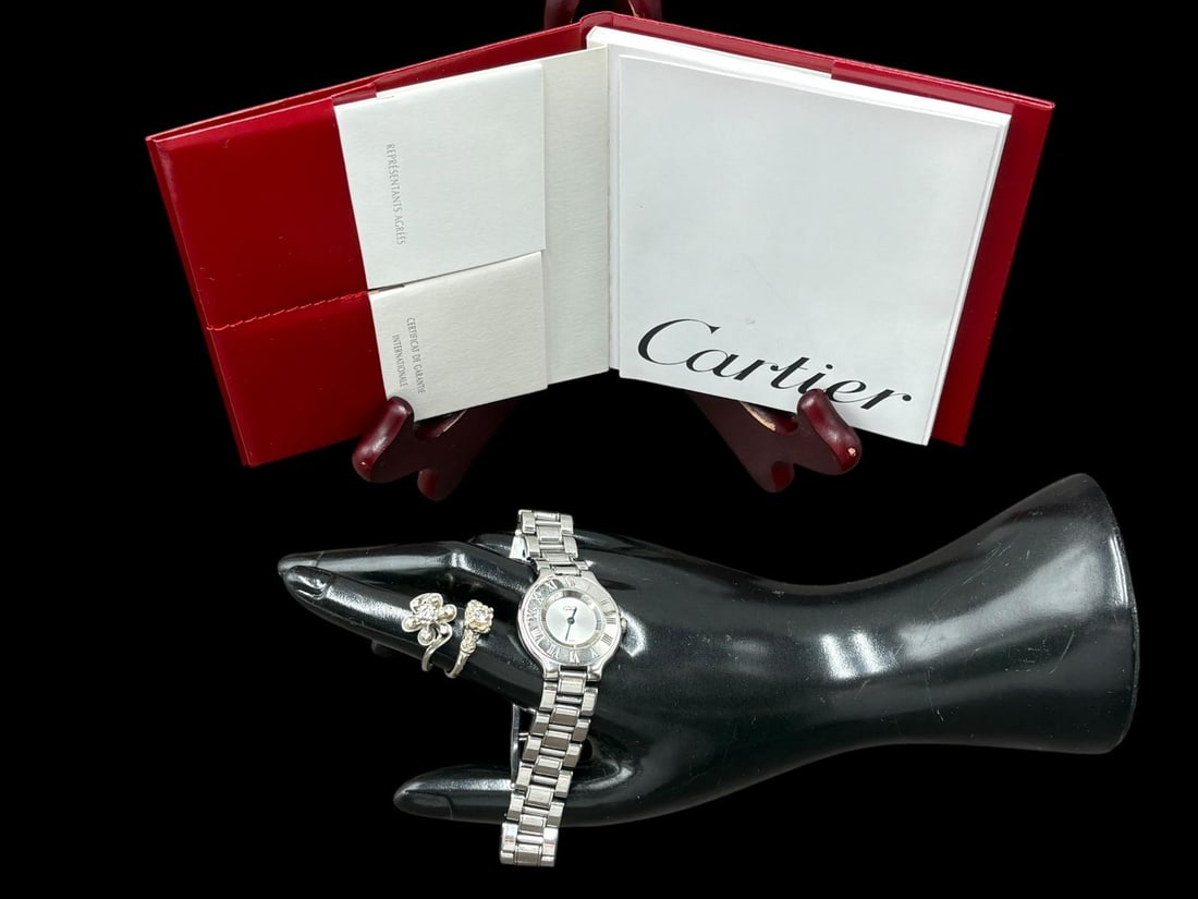 2-14k White Gold & Diamond Rings (7.50 Grams) & Authentic Cartier 28mm Ladies Watch: Estate Jewelry Lot of 2-14k White Gold & Diamond Rings & Cartier 28mm Ladies Watch. 1). 14k white gold flower shaped vintage ring with (approximate) 2mm center stone diamond with 6 small surrounding d