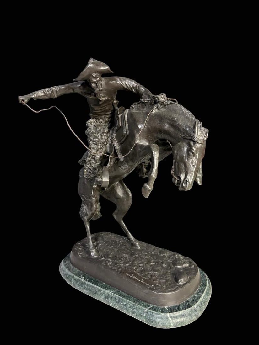 Frederic Remington (1861-1909) Bronze "The Bronco Buster" Signed - 22.5" Tall: Frederic Remington (1861-1909) Bronze "The Bronco Buster" Signed. This is a handsome piece of Western Art with cowboy riding his bronco. There is a triangle-in-a-circle symbol found on the hindquarter