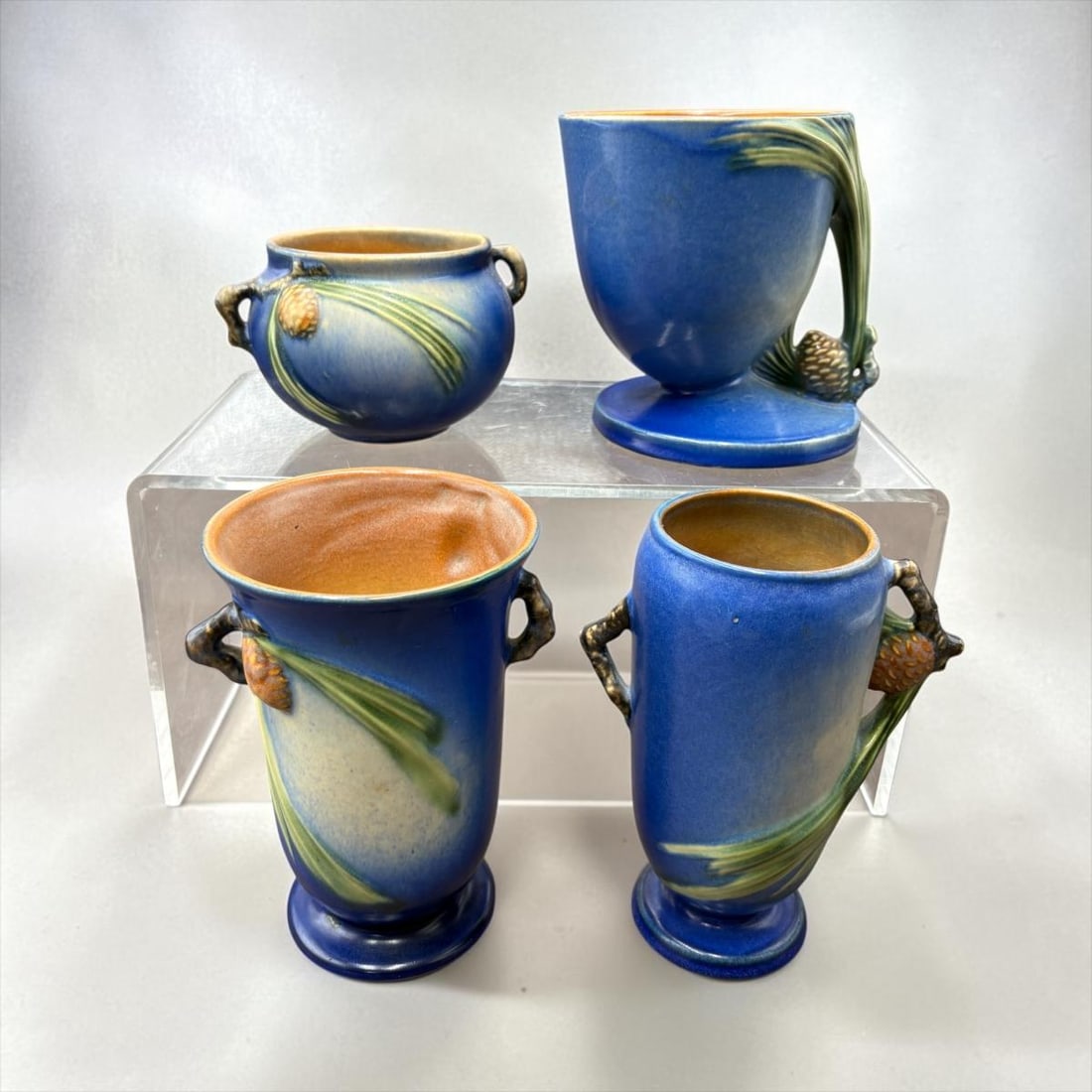 Lot of 4 1930's Roseville Pine Cone Blue Pottery Vases & Bowl: Lot of 4 1930's Roseville Pine Cone Blue Pottery Vases & Bowl. 1). Roseville 632-8 small 2 handled jardinière bowl. H 3.5" x W 5" (no chips or damage). 2). Blue Pine Cone 124 Cornucopia Flower Pot Pl