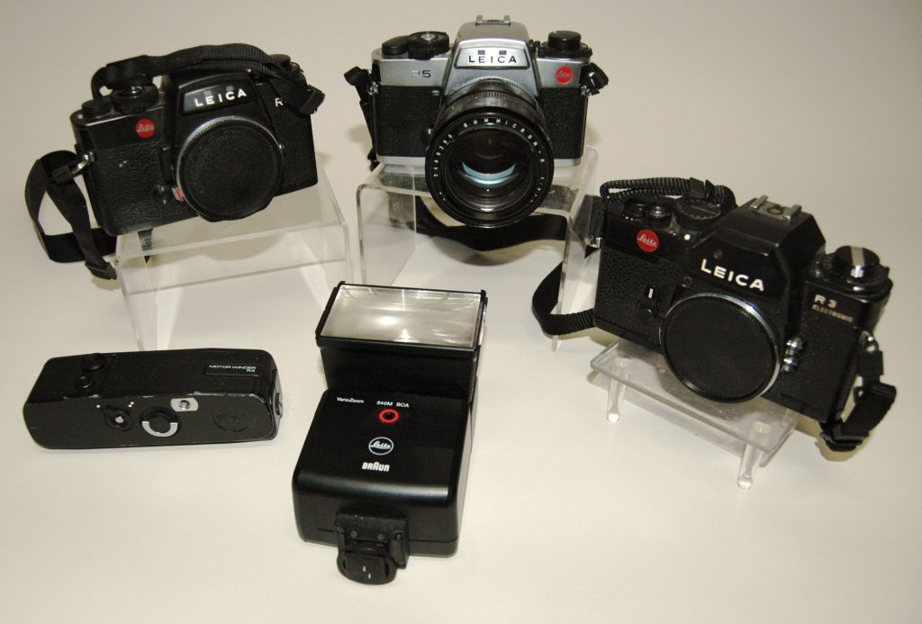 Group of 3 Leica Cameras: with accessories. The lot includes Leica R3, R4 and R5 bodies: accessories include Leitz Summicron-R lens, R4 motor winder, and Leitz Vario Zoom flash. All straight from estate and not tested. Good co