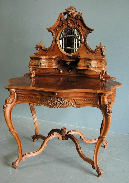 French Lady's Writing Desk: carved detachable top section with mirror and small drawers, serpentine shape in front and sides, single drawer with pull out leather surface for writing. Shaped stretcher base and cabriole legs. Very