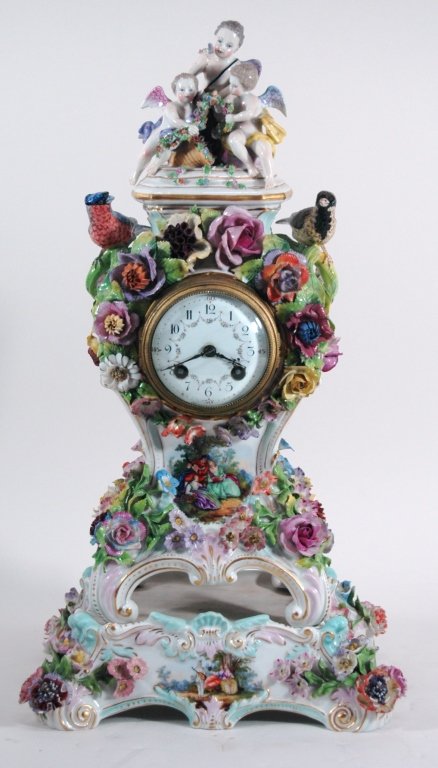 Important Meissen Style Porcelain Clock: 3 cherubs on top with birds on either side. Floral arrangement around face of clock, on porcelain stand. Early blue cross swords mark with "T". Hand painted porcelain enameled dial. Clock works are Ja